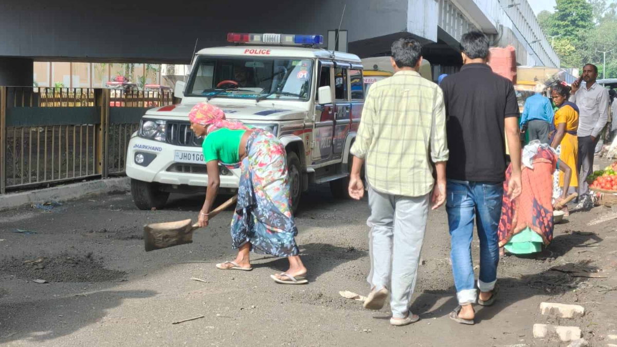 Laborers filling pothole